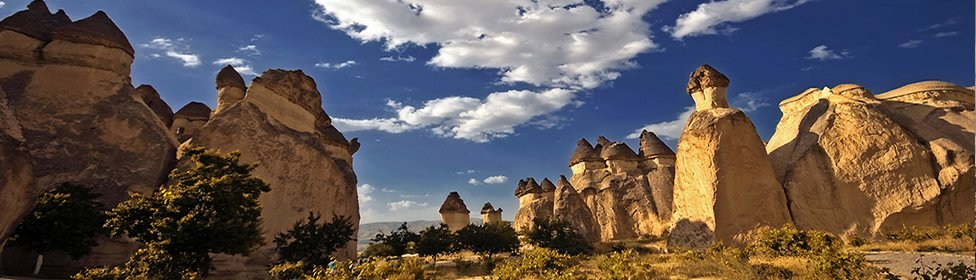 Cappadocia fairy chimneys illuminated beneath a deep blue sky