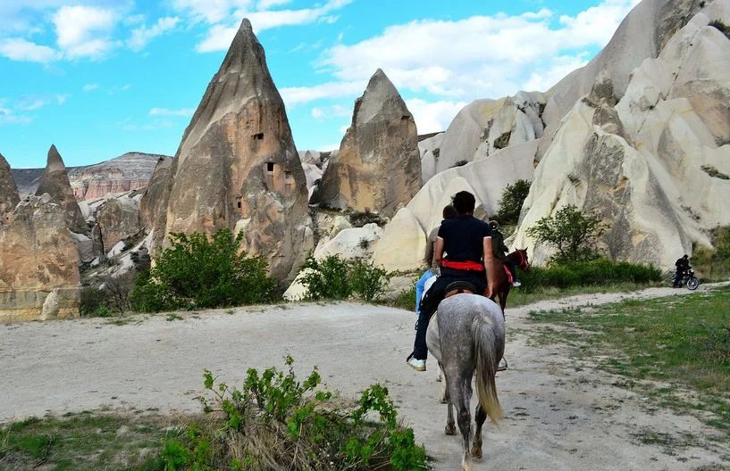 Horse riding through a Cappadocia valley