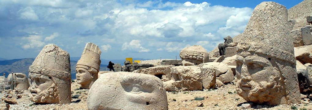 Monumental stone figures at Mount Nemrut in warm light